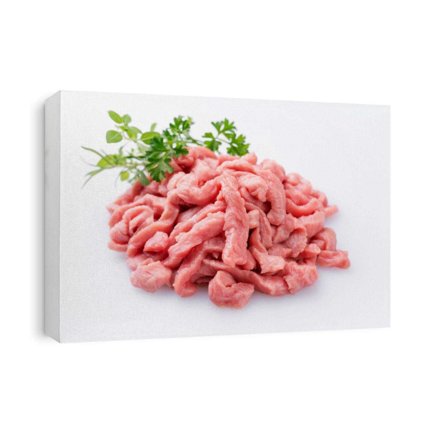 Raw veal strips for traditional Swiss zürcher geschnetzeltes with herbs as closeup on white background – isolated 