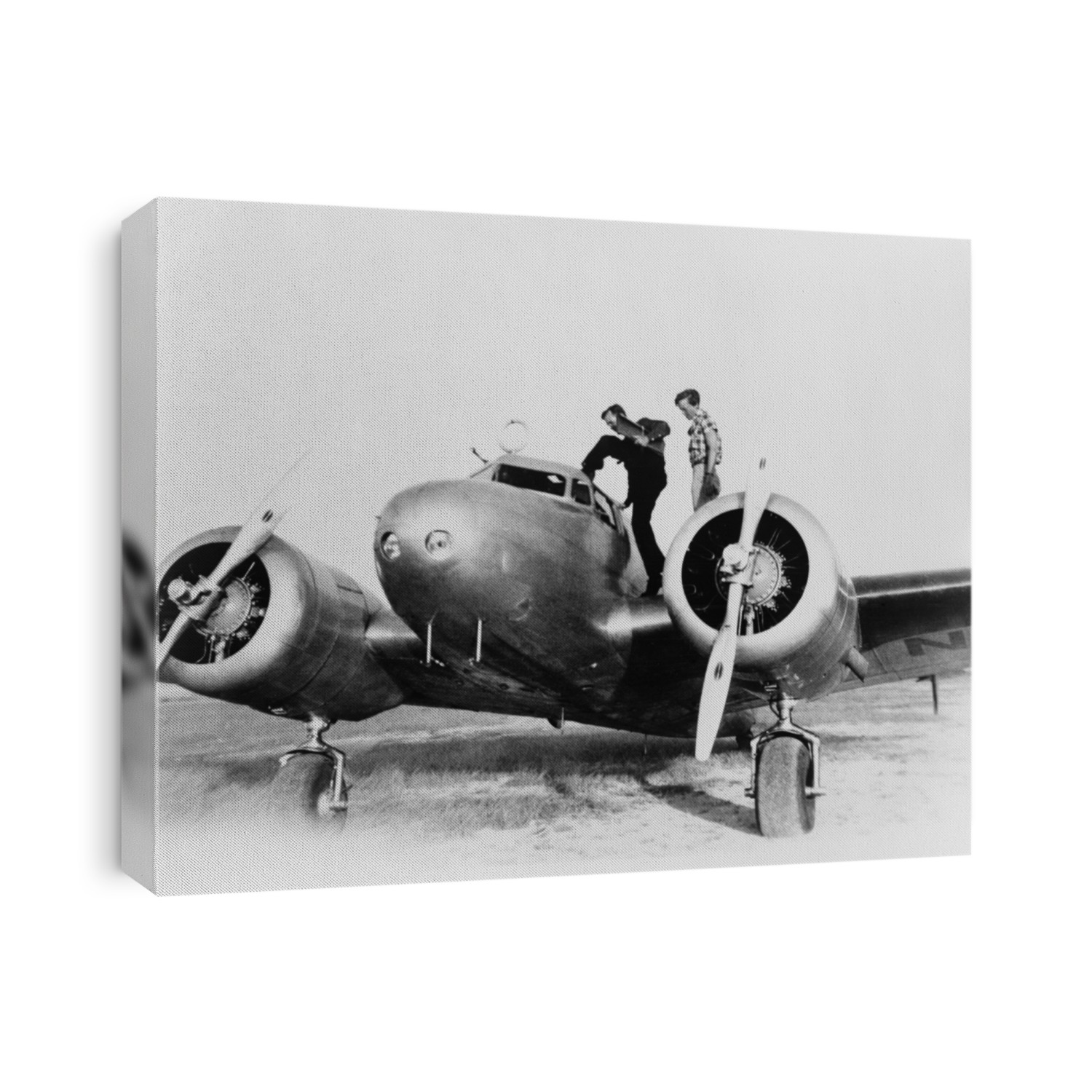 Amelia Earhart on wing of her Lockheed L-10E Electra airplane. At right is Fred Noonan, her navigator entering the cockpit, at a stop in Puerto Rico during their attempt to fly around the world. 1937.